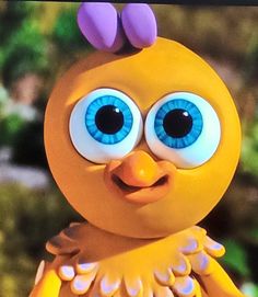 an animated yellow bird with big blue eyes