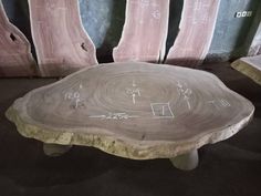 a table with writing on it in the middle of a room filled with wooden pieces