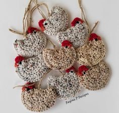 several crocheted chicken ornaments hanging from twine with red and white pomegranates