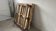 an old wooden crate sitting next to a white wall in a room with a door