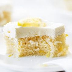 a piece of cake on a white plate with a bite taken out of the top