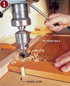 a person using a drill machine to cut wood with holes in the center and bottom