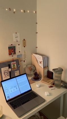 an open laptop computer sitting on top of a white desk