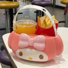 a hello kitty basket filled with food on top of a table