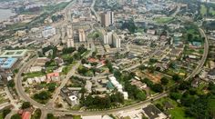 an aerial view of a city with lots of buildings and roads in the foreground