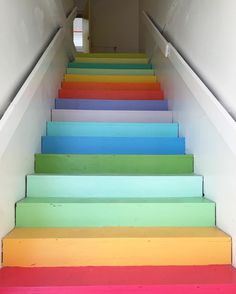 the stairs are painted bright colors and have hearts on each step to go down them