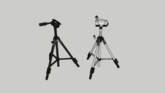 two tripod cameras sitting next to each other on top of a gray background,