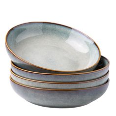 three bowls with gold rims stacked on top of each other in grey and white