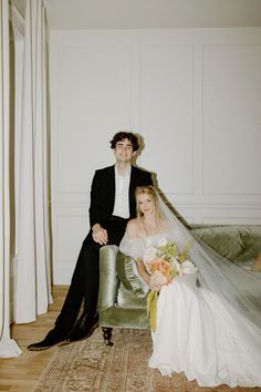 a bride and groom sitting on a couch