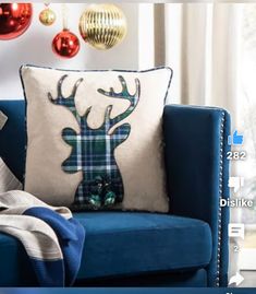 a blue couch sitting next to a christmas tree