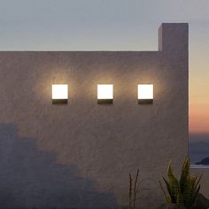 three square lights on the side of a building