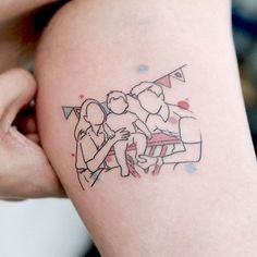 a woman's arm with a tattoo on it that has an image of two people hugging