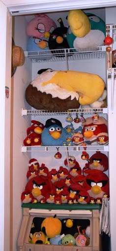 an open refrigerator filled with stuffed animals and other stuff animal items in it's shelves