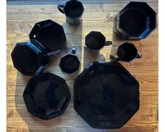 black plates and cups on a wooden table