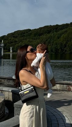 a woman holding a baby in her arms