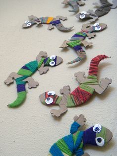 the paper lizards are all made up of yarn and thread, with numbers on them