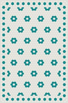 an image of a blue and white quilt with flowers on the front, in shades of teal