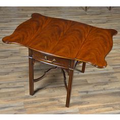 a wooden table with two drawers on one end and a drawer on the other side