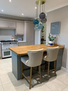 a kitchen with an island and two chairs