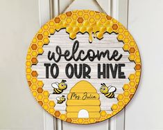 a wooden sign that says welcome to our hive