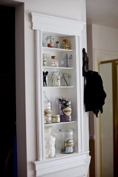 a white cabinet with shelves and built in magnets on the wall above it is an ad for pinterest