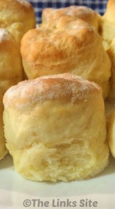 several biscuits on a plate with blue and white checkered table cloth