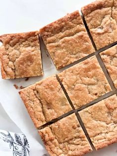 squares of brownies cut into squares sitting on top of a piece of parchment paper