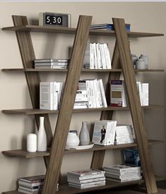 a bookshelf with several wooden shelves and white vases on the floor next to it