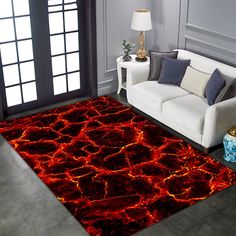 a living room area with a couch, chair and rug on the floor covered in red lava