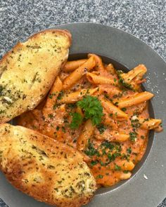 some food is on a plate with bread and garnished in parmesan sprinkles