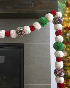 a decorated christmas garland with pom - poms hanging from it's side