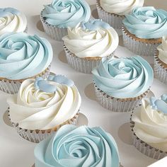 cupcakes with blue frosting in a white box