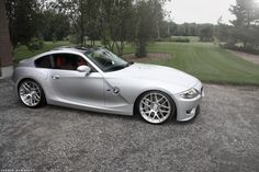 a silver sports car parked in front of a house