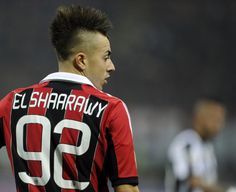 a soccer player wearing a black and red uniform