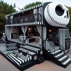 a black and white bus is decorated like a house