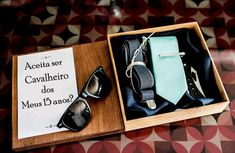 a wooden box with two ties and sunglasses in it