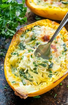 an egg dish with spinach and cheese in a yellow squash shell on a table