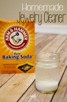 homemade jewelry cleaner and baking soda on a wooden table with text overlay that reads homemade jewelry cleaner pure baking soda