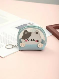 a small purse with a cat on the front and a keychain attached to it