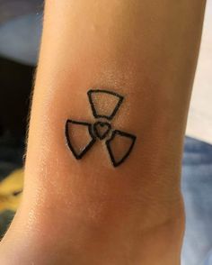 a black and white photo of a person's foot with a tattoo on it