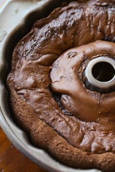 a cake pan with chocolate frosting in it