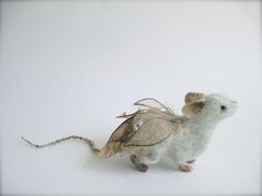 a stuffed animal mouse is shown on a white surface with no one in the photo