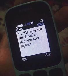 someone is texting on their cell phone with the message i still miss you but it don't want you back anymore