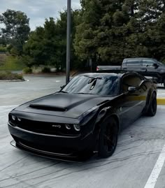 a black sports car parked in a parking lot