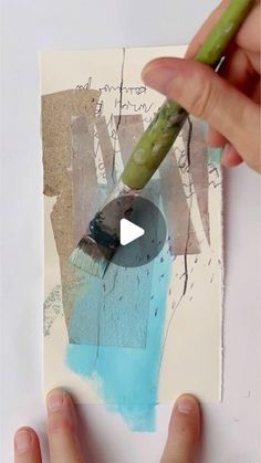 someone is using a paintbrush to create an abstract painting