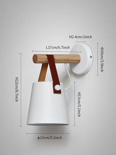 a white wall light with a wooden handle on it's side and measurements for the lamp