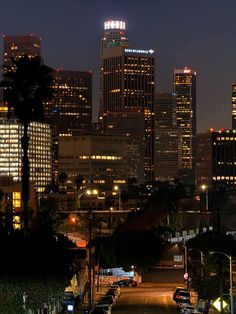 the city skyline is lit up at night