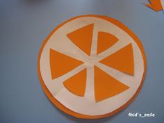 an orange and white paper cutout on a table