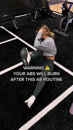 a woman is sitting on the ground with her head in her hands and text that reads, warning your abs will burn after this ab routine