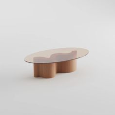 an oval glass table with two wooden bases